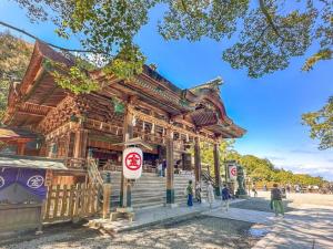 a wooden building with people standing in front of it at PolePole in Takamatsu
