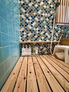 a bathroom with a wooden floor and a toilet at PolePole in Takamatsu +61 photos