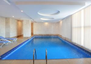 a large swimming pool in a hotel room at Karam Al Balad Hotel in Jeddah