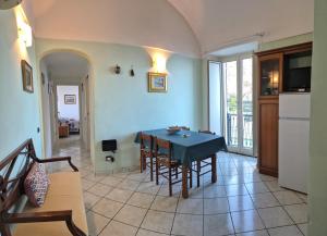 a living room with a dining room table with chairs at Dany House in Atrani