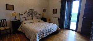 a bedroom with a bed and a large window at B&B Della Via Francigena in Agrigento