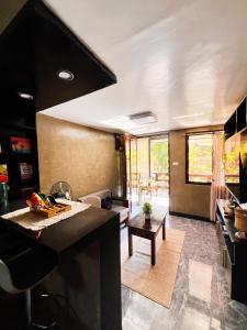 a kitchen and living room with a black counter top at Hidden Garden Villa in El Nido