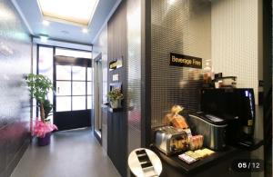 a waiting room with a toaster oven on a table at Prince Motel in Busan