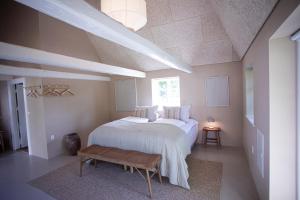 a bedroom with a white bed and a table at Gl. Brydegaard in Brydegård