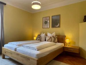 a bedroom with a large bed with yellow walls at Zur goldenen Krone in Ehrenhausen +21 photos