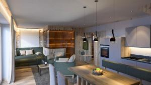 a kitchen and living room with a table and a couch at Schiefergut Family Resort Flachau in Flachau