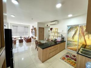 a kitchen with a table and a dining room at Saigon Getaway Apartment Thu Duc in Ho Chi Minh City