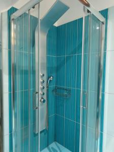 a bathroom with a shower with blue tiles at DENNIS PATRASSO - Modern apartment in Patras in Patra