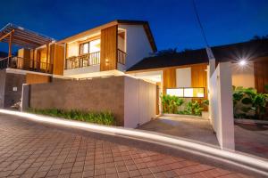 a house with a driveway at night at Omkara Dharman Ubud Villa By Omkara Experience in Ubud +19 photos