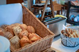 a basket of bread and pastries on a table at Hotel Alina in Wiesbaden
