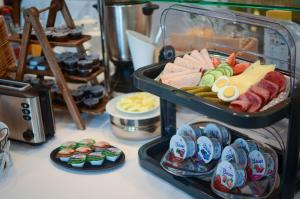a buffet of food on a table with plates of food at Hotel Alina in Wiesbaden