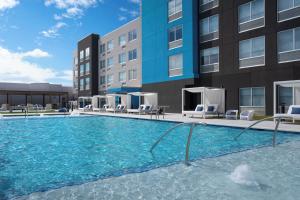 a swimming pool in front of a building at Tru By Hilton Wilmington in Wilmington
