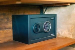 a black safe sitting on a wooden shelf at Turtle Villas, Canggu by Manara in Canggu