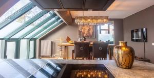 a kitchen with a table and a vase on a counter at Ospa in Hamois