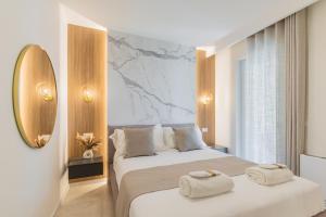 a hotel room with two beds with towels on them at Campo's Guest House Airport in Bari