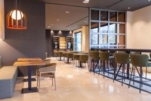 a bar in a restaurant with chairs and tables at SB Madrid Norte in San Sebastián de los Reyes