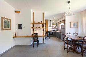 a kitchen and dining room with a table and chairs at Baveno Beach - Charming Flat With Garden in Baveno