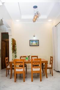 a dining room with a wooden table and chairs at KiliView Homestay in Moshi