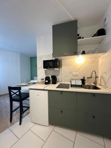 a kitchen with a sink and a counter top at Le Nid du Petit-Quevilly in Le Petit-Quevilly +7 photos