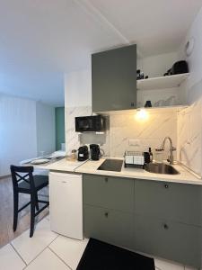 a kitchen with a sink and a counter top at Le Nid du Petit-Quevilly in Le Petit-Quevilly