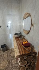 a bathroom with a sink and a mirror at Sandy Beach Villas in Toyapakeh