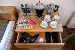 a table with a coffee maker and drinks on it at Majláthova Chata Popradské Pleso in Vysoké Tatry