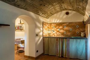 a kitchen with a counter and a wall with tiles at Villa Solenia in Giarre