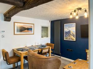 a dining room with a table and chairs at North Lakes Town House in Penrith