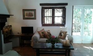 a living room with a couch and a table at El Aleznal in Trujillo