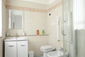 a bathroom with a toilet and a sink and a shower at Il Giardino di Valentina in Escolca +14 photos