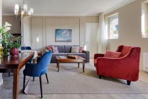 a living room with a couch and a table and chairs at Guild Siena Senior Resort & Residence in Siena