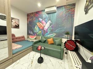 a living room with a couch and a colorful wall at Phương house in Long Biên