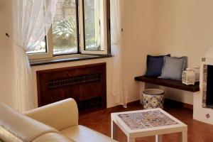 a living room with a couch and a window at Casa Vinaccia in Massa Lubrense