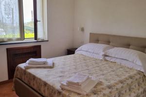 a bedroom with two beds with towels on them at Casa Vinaccia in Massa Lubrense