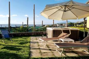 a patio with two chairs and an umbrella at Casa Vinaccia in Massa Lubrense