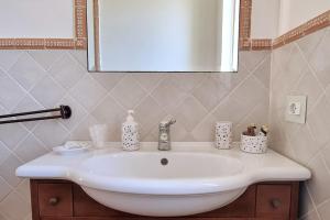 a white sink in a bathroom with a mirror at Casa Vinaccia in Massa Lubrense +18 photos