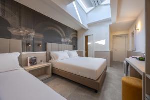 a hotel room with two beds and a skylight at Hotel Astoria Garden in Rome +65 photos
