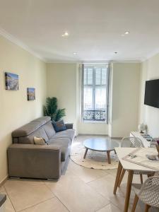 a living room with a couch and a table at HOSTEL MEYERBEER - Rooms and Apartments in Nice