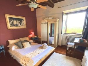 a bedroom with a bed and a large window at Torre Della Chiocciola in Monteriggioni +22 photos