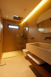 a bathroom with a tub and a toilet and a sink at Selimiye Sardunya Hotel & Restaurant in Marmaris +124 photos