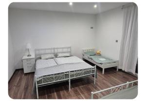 a bedroom with a bed and a nightstand and a bed sidx sidx sidx sidx at Apartma pri lovcu in Trzin