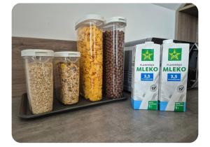 a group of four containers of cereal and some bags ofumes at Apartma pri lovcu in Trzin +3 photos