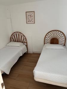 two beds sitting next to each other in a room at The Whiter House in Gáldar