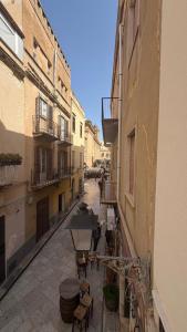 an alley with tables and chairs in a building at Le Cupole in Marsala