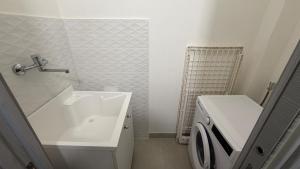 a bathroom with a sink and a washing machine at Le Cupole in Marsala +47 photos