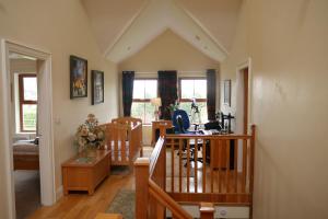 a living room with a table and a desk at Knockalla luxury property with hot tub suitable for families in Portadown