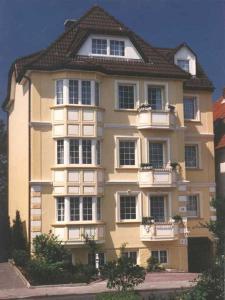 a large yellow building with windows and a roof at Nordsee 03 in Cuxhaven