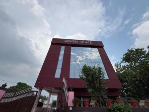 a tall building with a sign for a pizza palace at Tapasya Palace in Gorakhpur