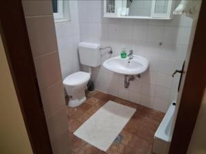 a bathroom with a toilet and a sink at Elma in Kampor