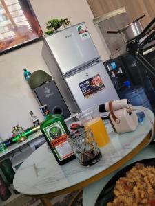 a kitchen counter with a table with food and a drink at Royal suburbs tsavo in Nairobi